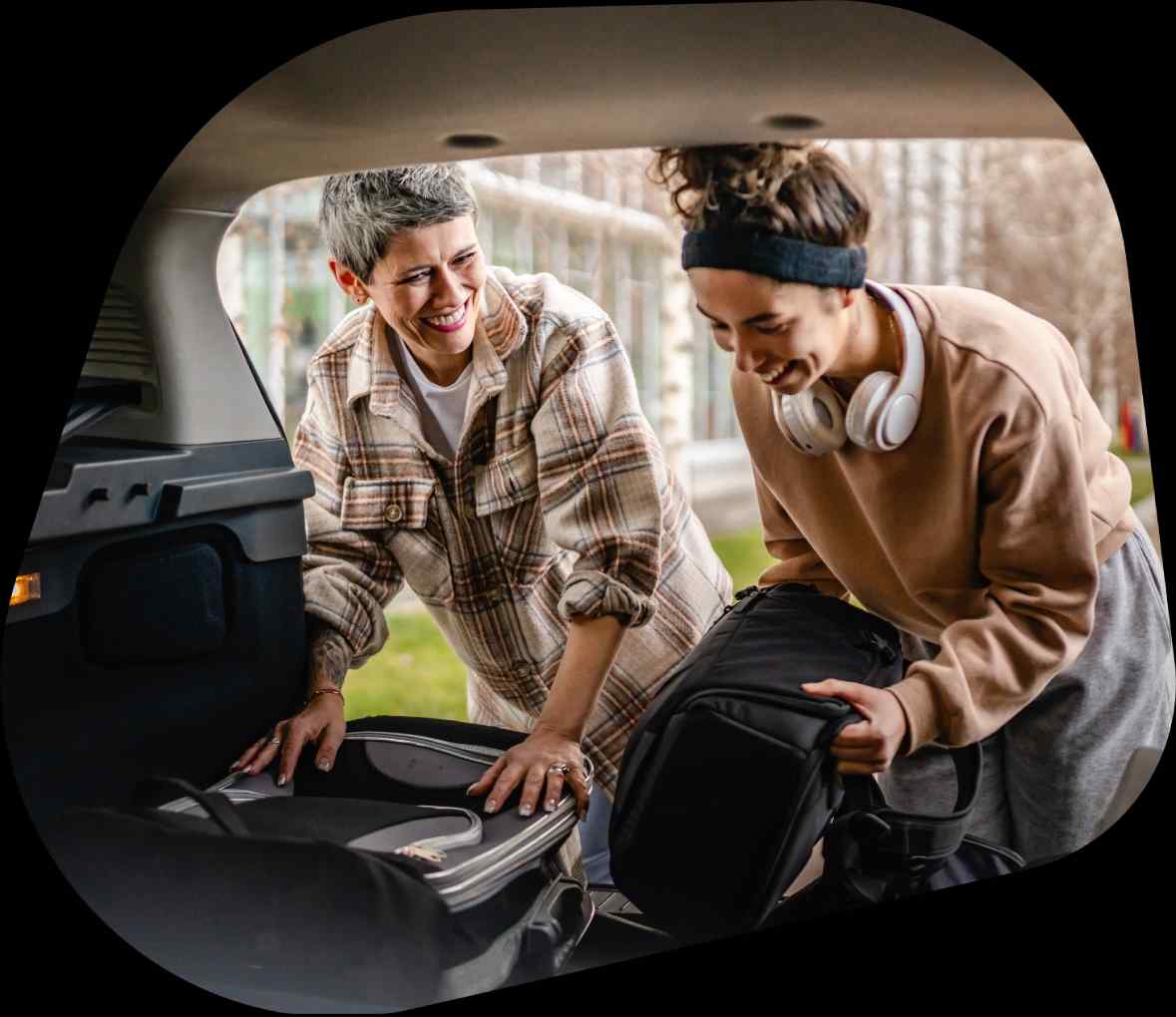 Parent and teenage child loading up a hatchback